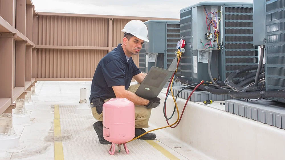 refrigerant a man changing ac unit refrigerant